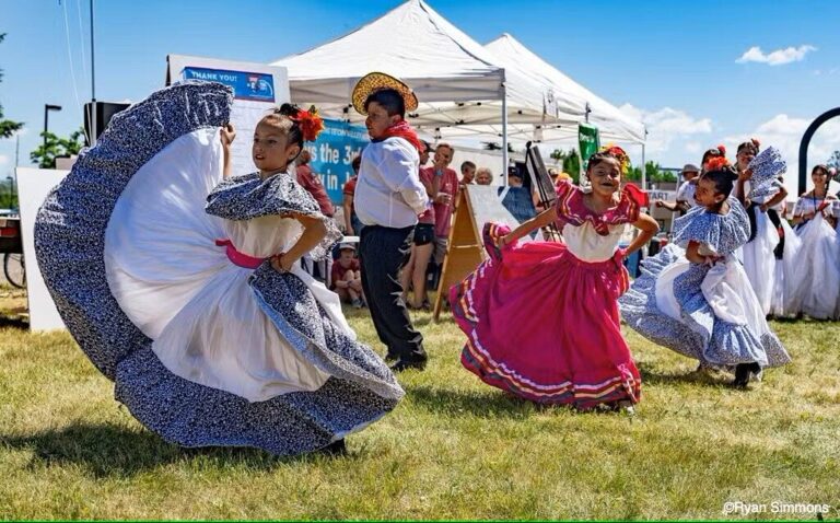 ladies dancing in colorful Hispanic dresses